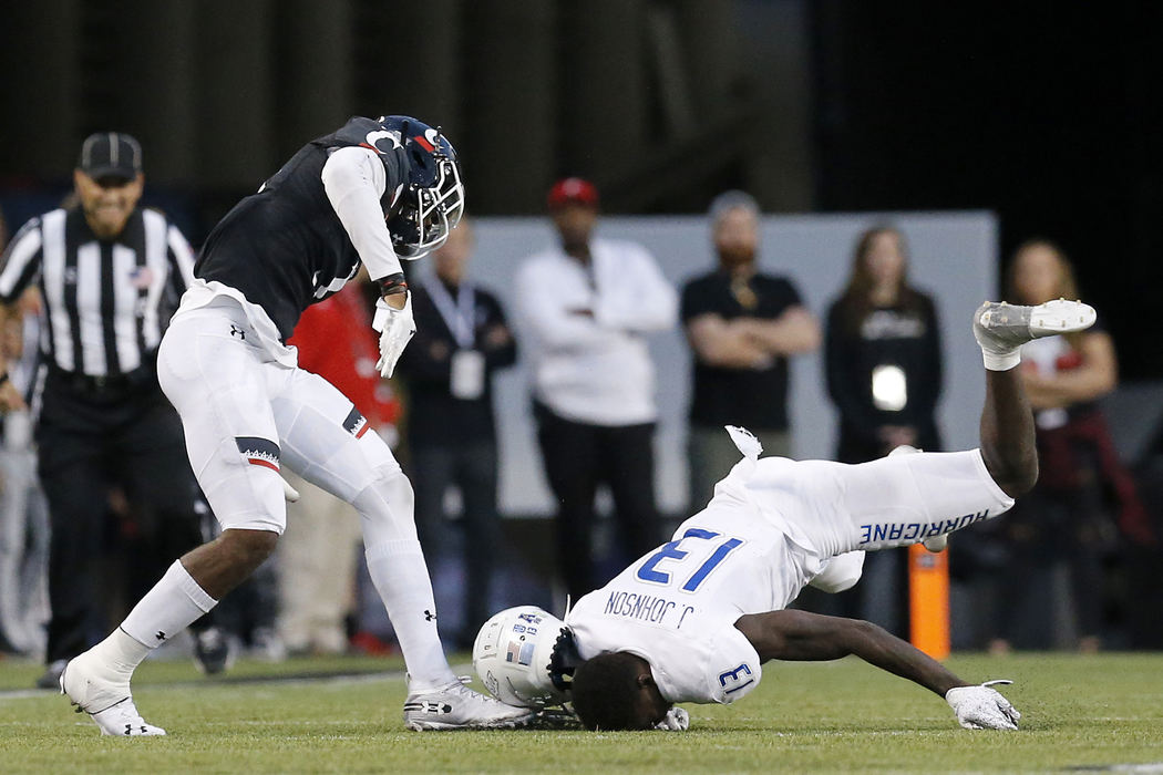 Sports - 3rd placeTulsa wide receiver Josh Johnson (13) lands on his head without his helmet after tangling with Cincinnati safety Ja'von Hicks over a deep pass in the fourth quarter of their game at Nippert Stadium in Cincinnati. (Sam Greene / The Cincinnati Enquirer)