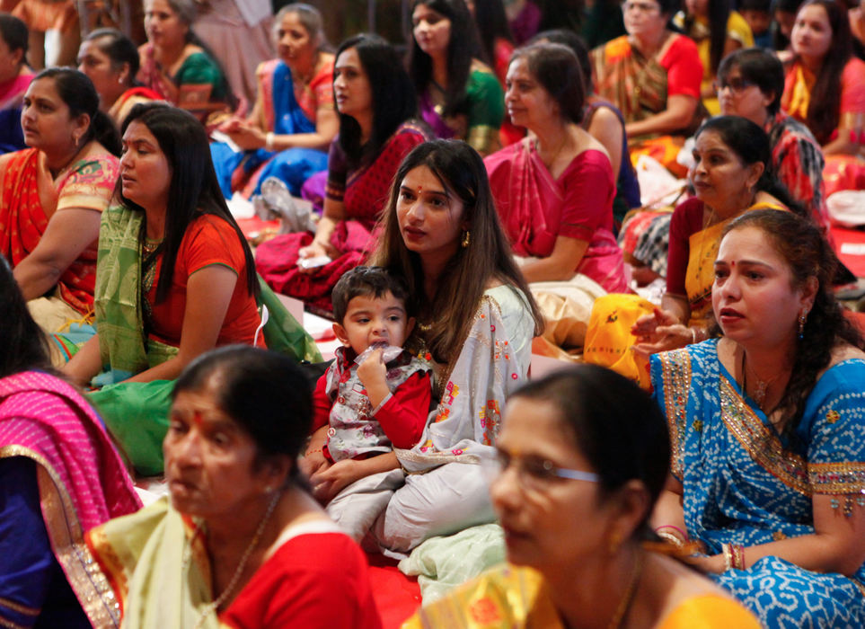 Story - 2nd placeA young boy chews on a small bag containing food as he sits with his mother during a prayer while celebrating Diwali at BAPS Shri Swaminarayan Mandir in Columbus. (Maddie Schroeder / The Columbus Dispatch)