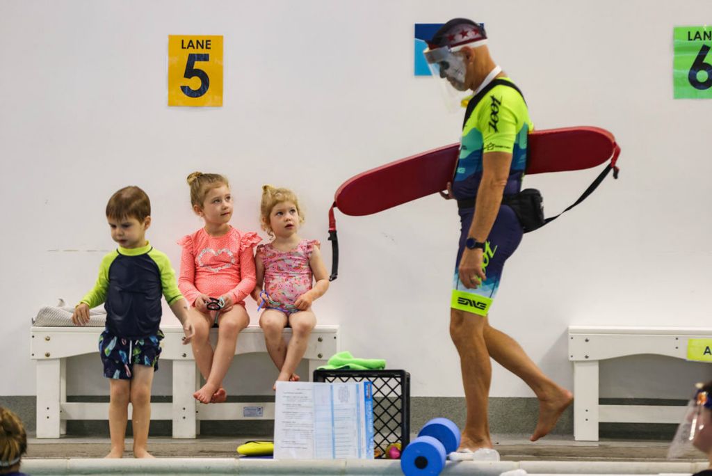 Feature - 3rd place - Girls watch as lifeguard Craig Werner walks by with a skull painted on his face at SafeSplash + SwimLabs in Holland. Swimmers used floating pumpkins of all sizes to learn different styles of swimming, floating and bouncing in the water.  (Rebecca Benson / The Blade) 