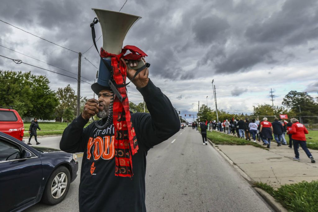 General News - 2nd place - JoJuan Armour, coordinator for the Initiative to Reduce Gun Violence, leads a march from North Detroit Avenue to St. Martin de Porres Church during a peace rally in Toledo. (Jeremy Wadsworth / The Blade) 