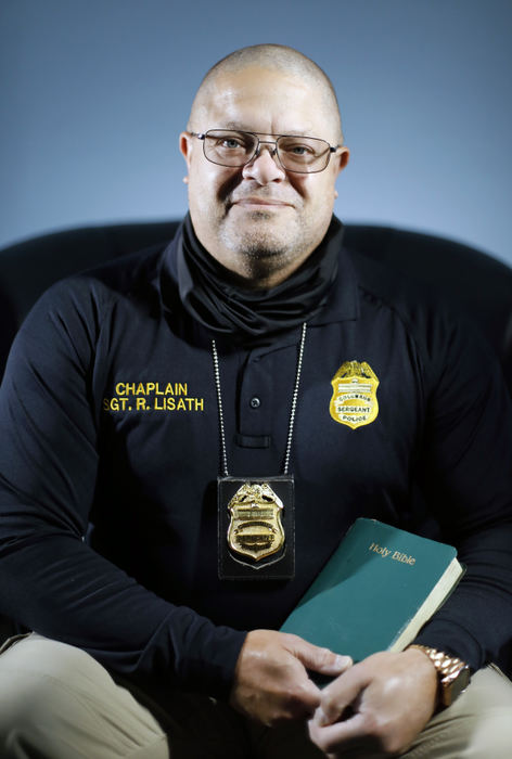 Portrait - 3rd place - Lt. Roy Lisath a chaplain and officer with Columbus Police poses for a photo at Grace and Mercy Fellowship Center in Columbus.  Columbus Police Chief Elaine Bryant said she wants 100 chaplains by 2026 in a talk at the Metro Club earlier this month. Columbus Police have 9 chaplains, including Roy.  (Kyle Robertson / The Columbus Dispatch) 