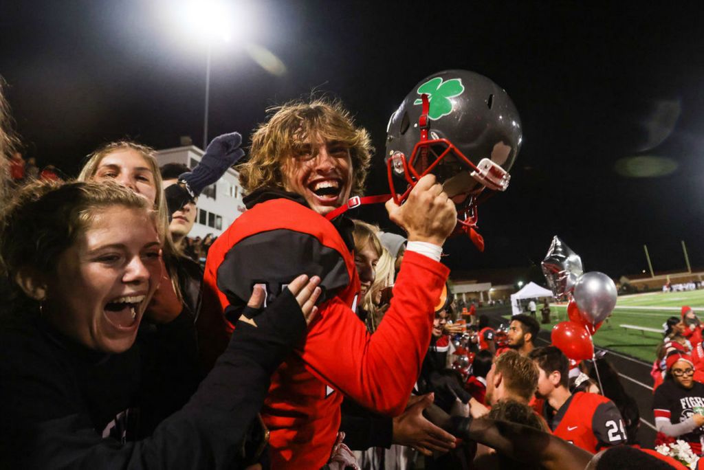 Sports Feature - 1st place - Central Catholic’s Jace Sanchez holds up his helmet as he celebrates with his team and the student section after defeating St. Francis de Sales’ 49-7 in a TRAC football game at Central Catholic High School in Toledo. (Rebecca Benson / The Blade) 