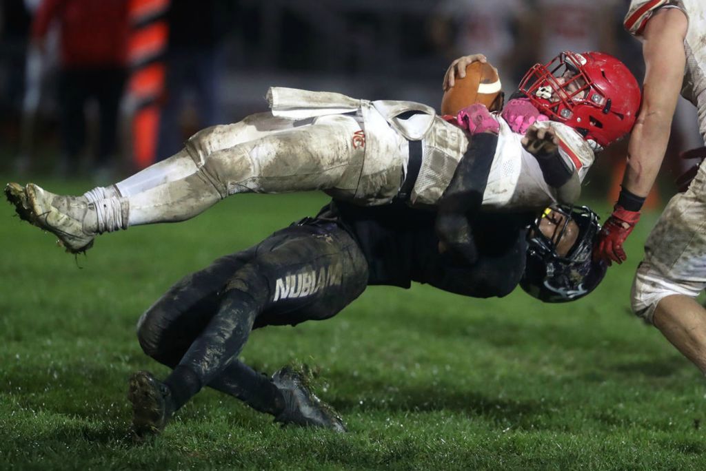 Sports - 2nd place - Africentric's Mekhi Johnson slams Worthington Christian's Hobie Raikes to the ground during a Division VI first round playoff game at Africentric Early College in Columbus. (Shane Flanigan / ThisWeek Community News) 