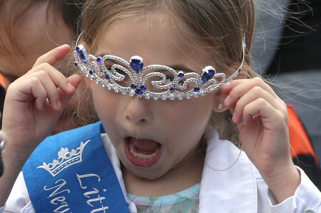 Feature - 1st place - Emalline Daugherty, 7, reacts as her crown keeps falling down over her eyes after she was crowned Little Miss Heritage of Flight at the Heritage of Flight Festival in New Carlisle.  (Bill Lackey / Springfield News-Sun)