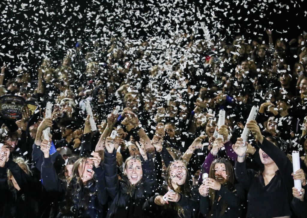 Sports Feature - 1st place - Ottawa Hills High School students set off confetti poppers in the student section at Niedermeier Stadium in Ottawa Hills.  (Lizzie Heintz / The Blade)