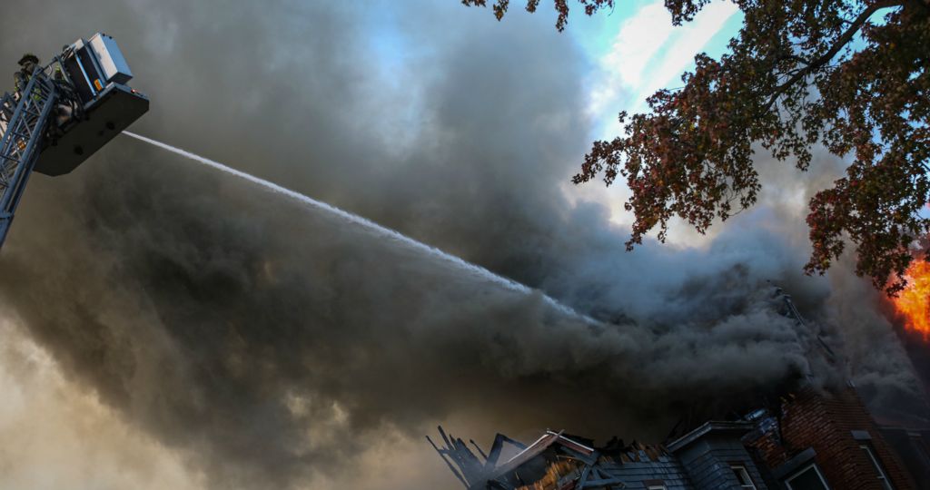 Spot News - 3rd place - Fire fighters respond to a fire in a vacant building on the corner of Fulton Street and Winthrop Street in Toledo. (Lizzie Heintz / The Blade)