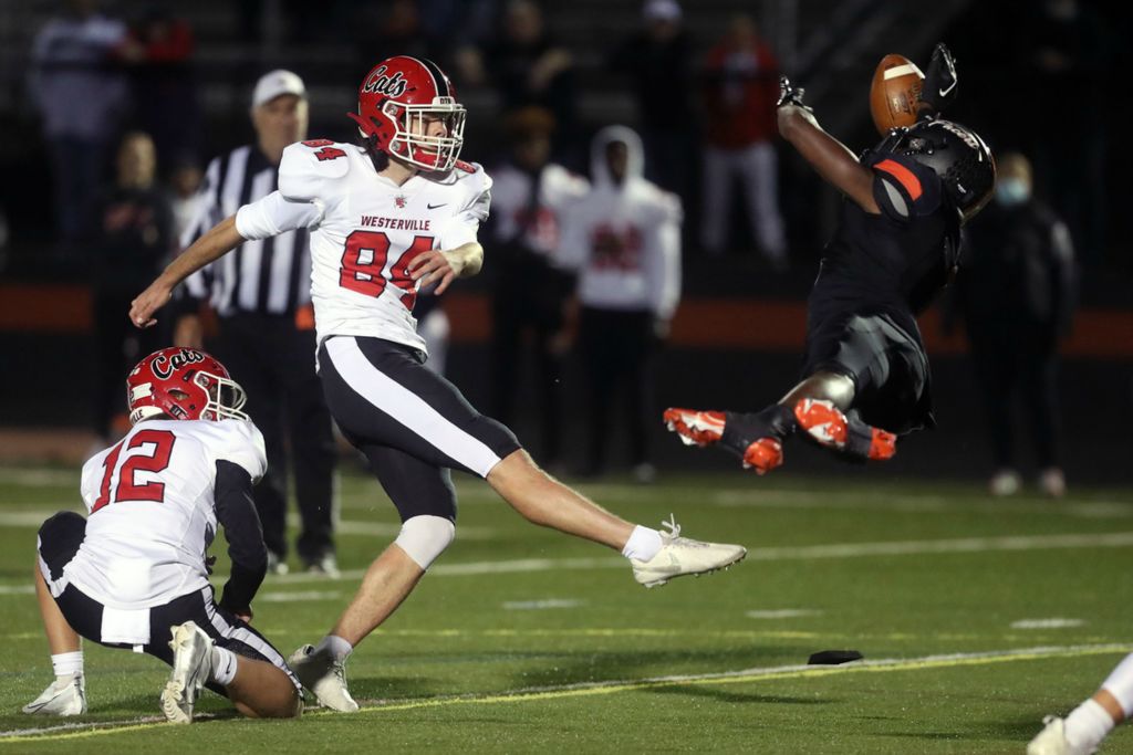 Sports - 1st place - Delaware Hayes' Xavier Weaver blocks an extra-point attempt from Westerville South's Quentin Sheets during a game at Rutherford B. Hayes High School in Delaware. (Shane Flanigan / ThisWeek Community News)