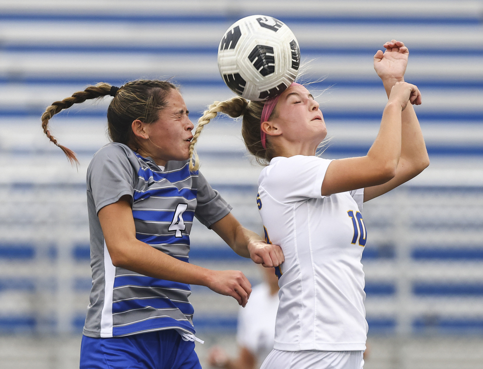 Sports - 3rd place - Anthony Wayne’s Kiana Harsh (left) battles  St. Ursula’s Emma Helminski for the ball during a Division I district semifinal game at Springfield High School in Holland.  (Jeremy Wadsworth / The Blade)