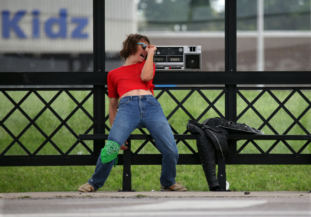 Feature - 2nd place - Shawn Hayes, of Columbus, sings along with the soundtrack Bad Reputation by Joan Jett at a bus stop along Hamilton Rd. in Columbus. Shawn calls himself an aged teenager and often comes to the bus stop to use it as a performance space.  (Eric Albrecht / The Columbus Dispatch)