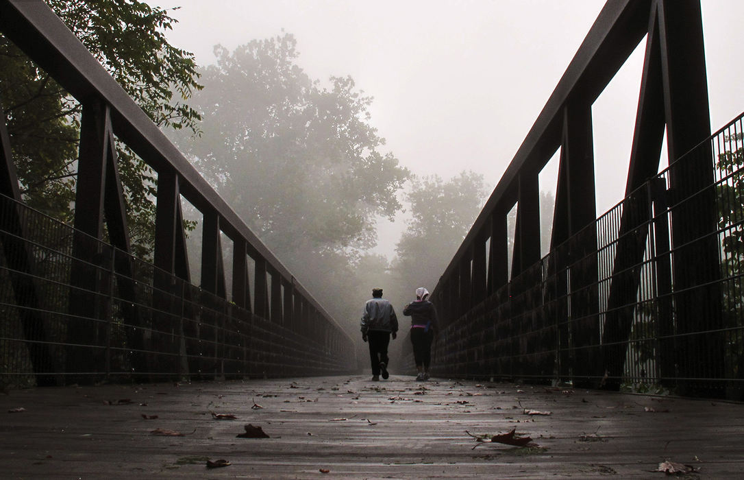 Feature - 3rd place - A couple enjoy a stroll across the bridge on a foggy morning that spans Big Walnut Creek at Three Creeks Metro Park .        (Eric Albrecht / The Columbus Dispatch)