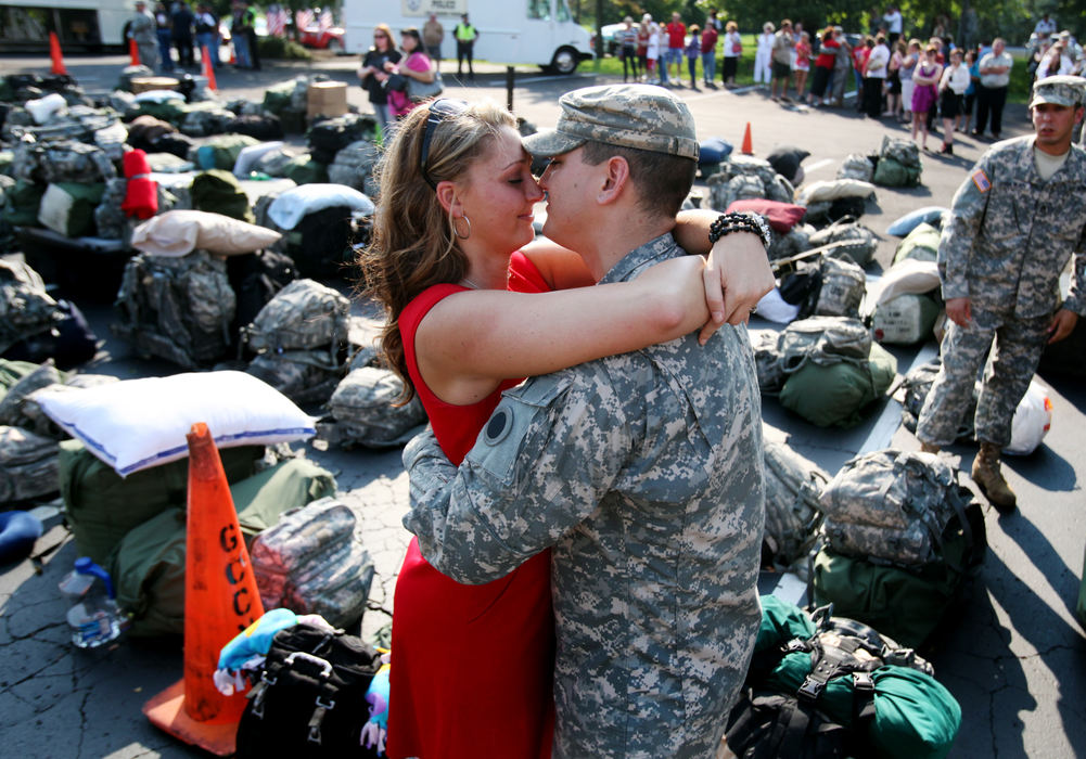 General News - 1st place - Lt. Brendan Lucas says goodbye to his wife Kimberly Lucas at their deployment ceremony at Grove City Nazarene Church. They married in July because of the deployment. (Eric Albrecht / The Columbus Dispatch)