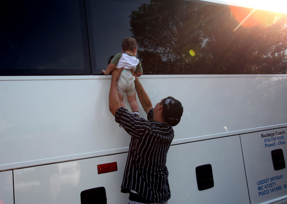 Story - 3rd place - Aaron Clark holds up his 18 month-old nephew James Clark so his dad James Clark of the 134th Field Artillery Regiment on the bus can see him one final time at the deployment ceremony at Grove City Nazarene Church. (Eric Albrecht / The Columbus Dispatch)