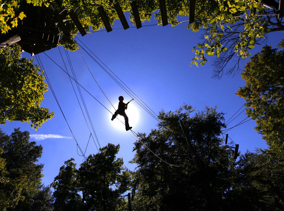 Feature - HMMax Wing, a seventh grader at The Wellington School, participates on the ropes course in a team-building field trip at Camp Lazarus in Delaware. The class spent the day doing different team-building events that featured risk-taking, failure and problem solving. The annual trip prepares the seventh graders with team skills that will help them during a trip next month to Washington, D.C. (Jonathan Quilter / The Columbus Dispatch)