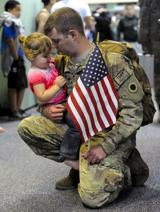 General News - 2nd placeFaith Rodenberger, 21-months-old, gets to know her father, Sgt. Jason Rodenberger, of Marion as he arrives at Rickenbacker Airbase with 240 other National Guardsmen who have deployed to Afghanistan for the past year.  (Bill Lackey / Springfield News-Sun)