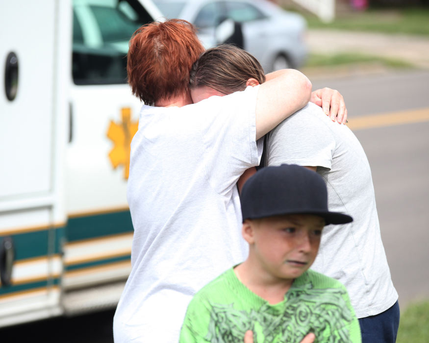 Spot News - 2nd placeThe driver of a Pontiac sedan (right) is comforted following a two-vehicle crash in Ashtabula. The boy is the driver's son. (William A. West / Wwest News Service)