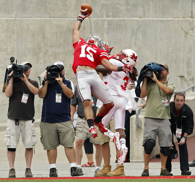 Sports - 1st placeOhio State wide receiver Devin Smith (15) makes a one handed touchdown catch with Miami Redhawks cornerback Dayonne Nunley defending on the play. (Kyle Robertson / The Columbus Dispatch)