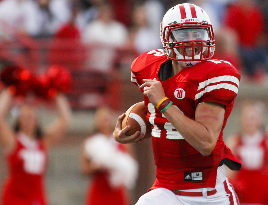 Sports - 2nd placeWittenberg quarterback Reed Florence puts on a happy face while running along the sideline en route to scoring a touchdown during the Tigers' game against DePauw at Edwards-Maurer Field. (Barbara J. Perenic / Springfield News-Sun)