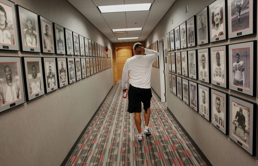 Story - 1st placeOhio State head football coach Urban Meyer walks through the Woody Hayes Athletic Complex to meet some players. (Eric Albrecht / The Columbus Dispatch)