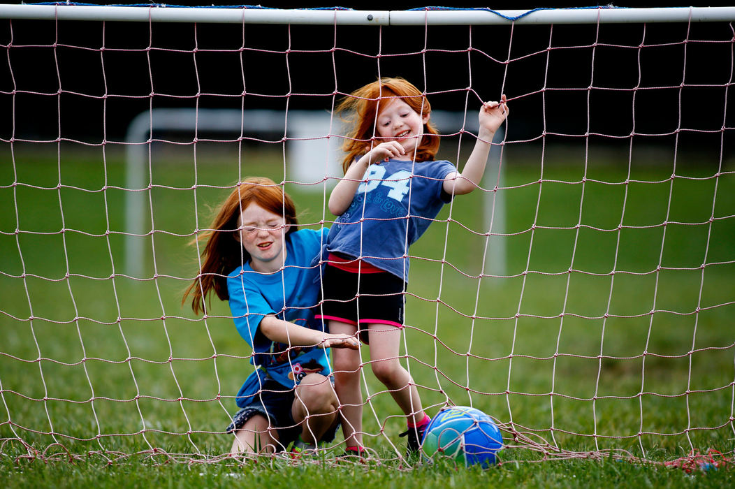 Feature - 1st placeZoe Whitmer, 9, left, and her sister Ella Whitmer, 5, right, get a bit silly as they retrieve a soccer ball in the goal at Murfin Memorial Fields in Grove City.   (Fred Squillante / The Columbus Dispatch)