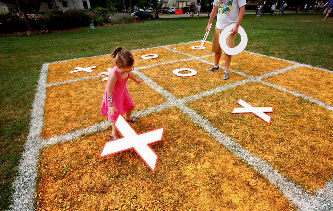 Feature - HMThis year's Upper Arlington Arts Festival included Tic-Tac-Toe games painted on grass.  Sophia Bixler, 4, places her 'X' as she plays with her dad, Dustin Bixler. (Fred Squillante / The Columbus Dispatch)