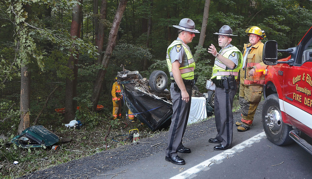 Spot News - 2nd placeHighway patrol Sgt. Craig Monte and trooper Kevin Thompson investigate a single vehicle rollover crash on SR 7 that claimed the life of a 43-year-old Rogers man and injured his passenger, also of Rogers.  (Patricia Schaeffer / The (Lisbon) Morning Journal)