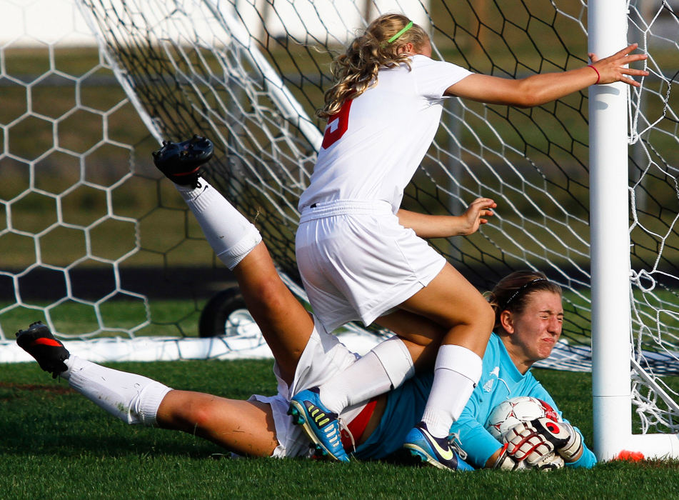 Sports - 3rd placeColumbus School for Girls' goalkeeper Olivia Feldman saves the ball as Worthington Christian's Aubrey Windsor (9) tries to avoid a collision. (Joshua A. Bickel / ThisWeek Newspapers)