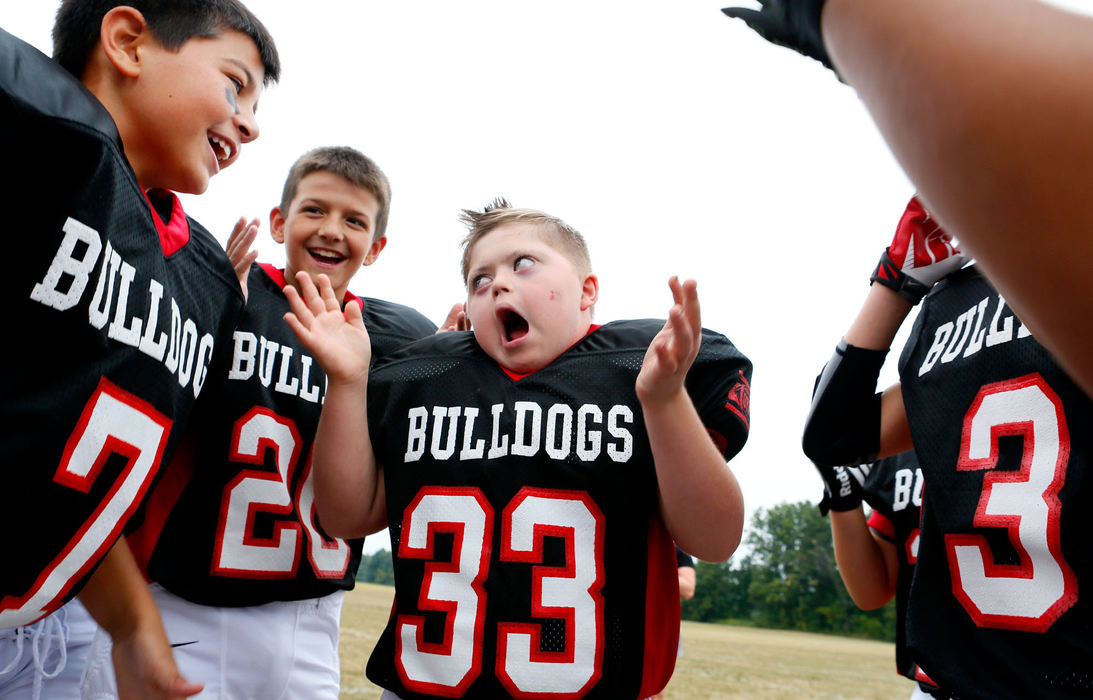 Story - 1st placeSeptember - First place Picture StoryEric Albrecht/The Columbus DispatchMurphy Vetter, 11, who has autism leads his team, the Bulldogs, in pre-game huddles. Murphy's family got permission from the league to play youth football to help him interact with other peers. Murphy has developed relationship with teammates on and off the field. (Eric Albrecht / The Columbus Dispatch)