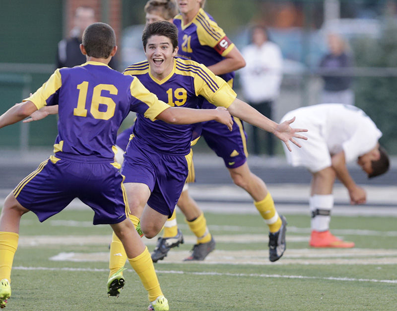 Sports Feature - 3rd place - Jackson's Cameron Biros (19) celebrates with teammate Zach Pence (16) moments after Biros scored for the Polar Bears. At right, GlenOak defender Nathan Blaydes reacts to the only score of the game.  (Scott Heckel / The (Canton) Repository)