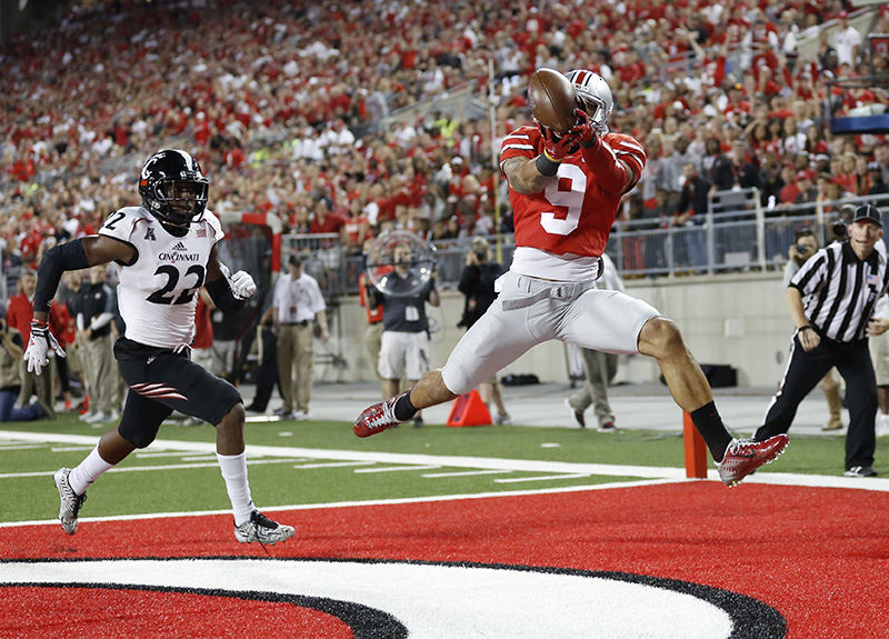 Sports - HM - Ohio State wide receiver Devin Smith (9) catches a touchdown pass behind Cincinnati safety Zach Edwards (22) during the fourth quarter of their game at Ohio Stadium in Columbus. (Adam Cairns / The Columbus Dispatch)