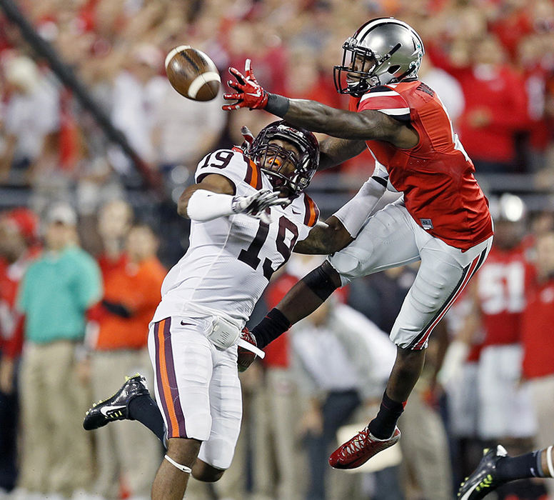 Story - 3rd place - Ohio State running back Dontre Wilson (right) comes up with the one handed catch against Virginia Tech cornerback Chuck Clark during the 2nd quarter of their game at Ohio Stadium. (Kyle Robertson /  The Columbus Dispatch)