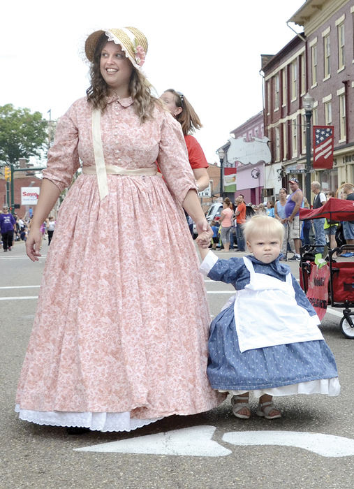 Feature - 1st place - The Baer and Hissom families of Leetonia march in the Spirit of Johnny Appleseed during the 48th annual Johnny Appleseed Festival parade.  (Patricia Schaeffer / The (Lorain) Morning Journal)