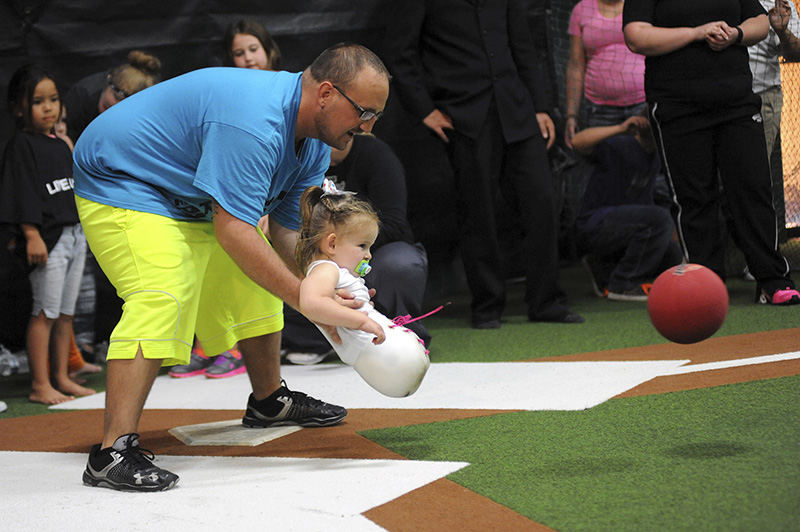 General News - 3rd place - Sean Calendine helps his daughter Paige hit a ball during a kickball game for the United Way of Muskingum, Perry and Morgan counties' annual fundraising campaign at the Fieldhouse Sports and Wellness Center in Zanesville. (Shane Flanigan / Zanesville Times Recorder)