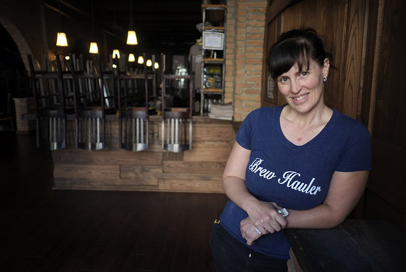 Portrait - 2nd place - Shannon Fink, head brewer at Black Cloister Brewing Co, in their tap room.  Fink was a registered nurse for 11 years before becoming interested in homebrewing. “I knew from the first time I did it that I was hooked,” she said. “Even though the first batch I did was a complete disaster, it only made me want to do it more.” (Andy Morrison / The (Toledo) Blade)