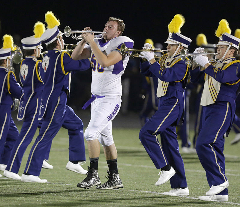 Sports Feature - 2nd place - Jackson football player Bobby Baker marches with the band during half time of their game at GlenOak High School. (Scott Heckel / The (Canton) Repository)