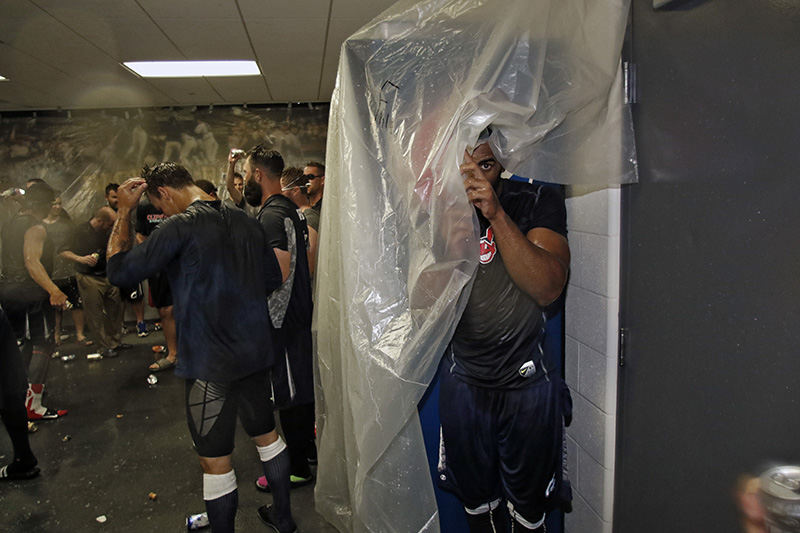 sSports Feature - HM - Columbus Clippers Yandy Diaz (7) hides under plastic as the Clippers celebrate after beating Norfork 5-0 and winning the series at Huntington Park in Columbus.   (Kyle Robertson / The Columbus Dispatch)