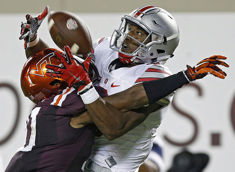 sSports - 2nd place - Virginia Tech cornerback Kendall Fuller (11) is called for pass interference against Ohio State wide receiver Michael Thomas (3) in the end zone at Lane Stadium in Blacksburg, Va.   (Kyle Robertson / The Columbus Dispatch)