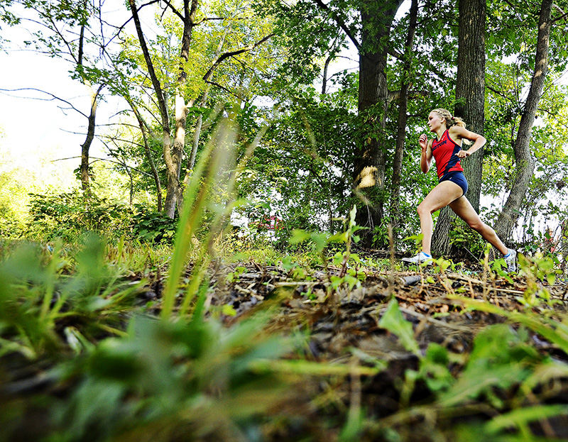 Sports - HM - Dayton's Emily Leonard races through the woods on her way to winning the Flyer 5k invitational. (Erik Schelkun / Elsestar Images)