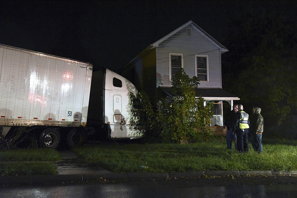 Spot News - 2nd place - An unattended semi truck collided with a pair of houses on South State Street in Zanesville. The semi driver exited the vehicle to tend to a problem with the trailer when the semi got away from him. No major injuries were reported. (Shane Flanigan / Zanesville Times Recorder)