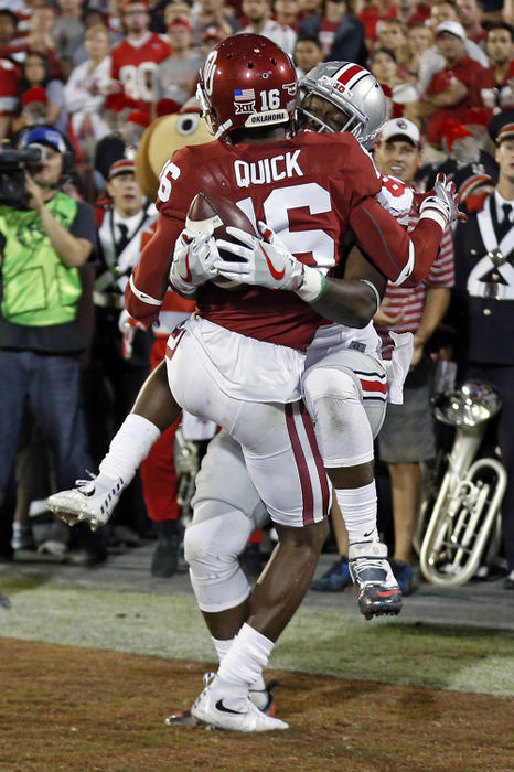 Sports - 2nd place - Ohio State wide receiver Noah Brown (80) makes his third touchdown catch against Oklahoma Sooners defensive back Michiah Quick (16) in the second quarter at Oklahoma Memorial Stadium in Norman, Oklahoma.   (Kyle Robertson / The Columbus Dispatch)