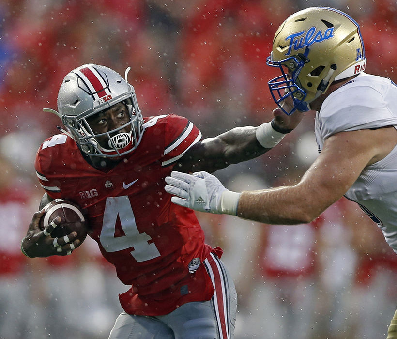 Sports - 3rd place - Ohio State running back Curtis Samuel (4) gets tackled by Tulsa defensive tackle Jesse Brubaker (8) in the 3rd quarter of their game at Ohio Stadium in Columbus. (Kyle Robertson / The Columbus Dispatch)