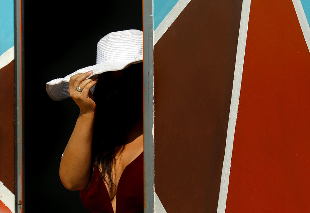 Feature - 3rd place - A woman peeks out of the colorful Sophia Quintero Art and Cultural Center in Toledo. (Andy Morrison / The Blade)