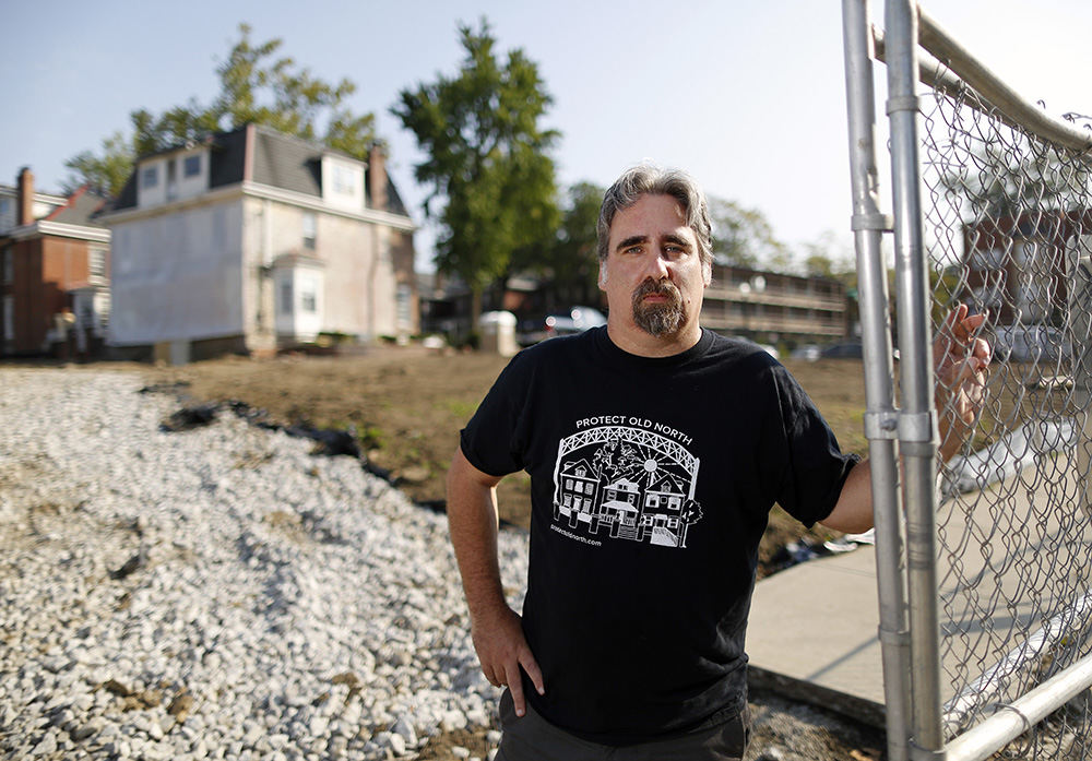 Portrait - 2nd place - Aaron Marshall of the University Area Commission stands in front of the Pavey block construction site on the corner of N. High Street and W. Northwood Avenue in Columbus.  Marshall is an opponent of the project  and has concerns about how zoning is done.    (Kyle Robertson / The Columbus Dispatch)