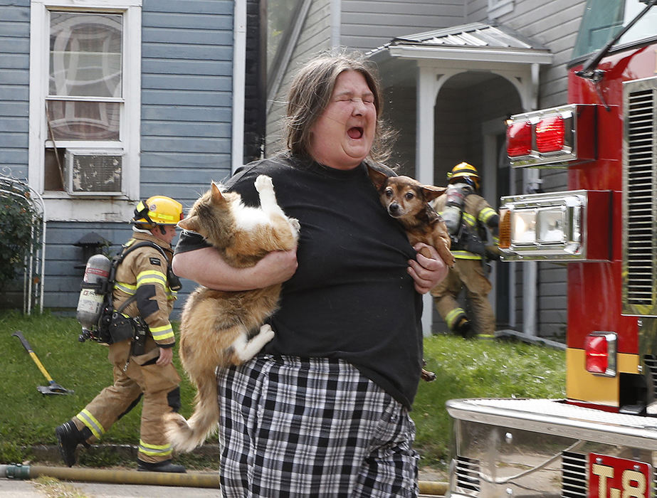 Spot News - 3rd place - Tonya Stevens carries her dog and cat after escaping her burning house with her elderly mother and son in the 500 block of East Pleasant Street. Stevenson said her dog saved her life by waking her up.  (Bill Lackey / Springfield News-Sun)