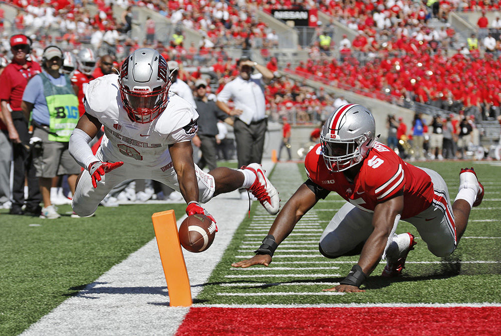 Sports - 1st place - UNLV running back Lexington Thomas (3) scores a touchdown while defended by Ohio State linebacker Baron Browning (5) during the second quarter at Ohio Stadium in Columbus.  (Barbara J. Perenic / The Columbus Dispatch)