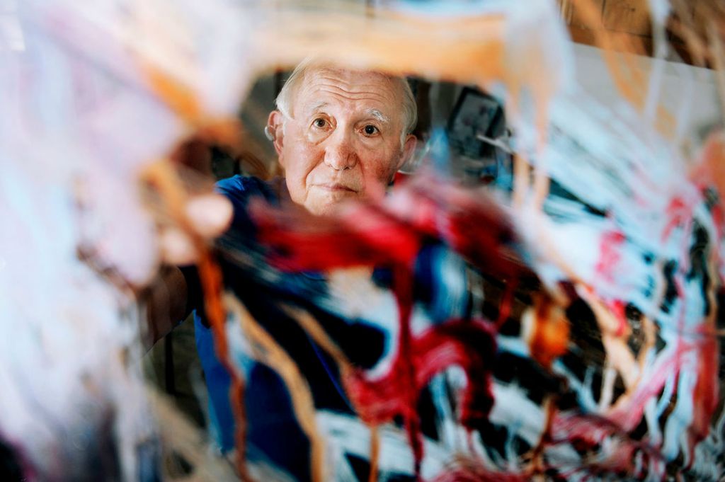 Portrait - 1st place - Ralph Stuckman, 84, is seen through a "dripping" paint piece at his home studio. Stuckman, who founded The Lake Area Arts Group, is stepping down as the groups' director.(Daniel Melograna / The Daily Standard)