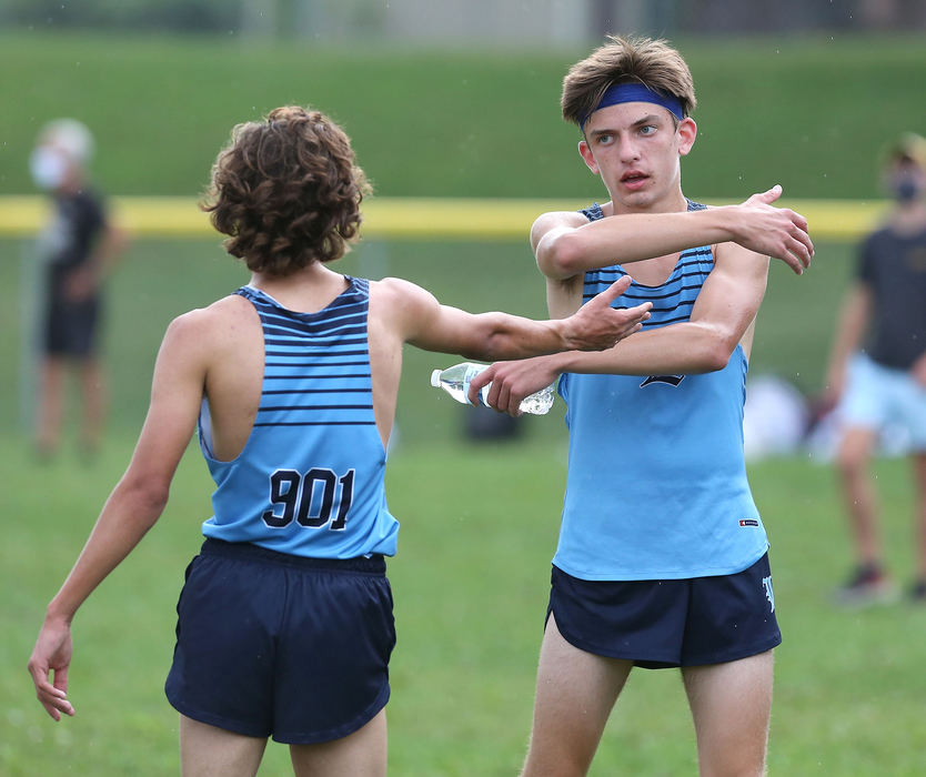 Sports Feature - 2nd place - Bobby Ganser (right) of Louisville gives a virtual hug to teammate Colby Adams after the big school division of the East Canton Cross Country Invitational. Ganser finsihed first while Adams finished second. (Scott Heckel / The Repository)