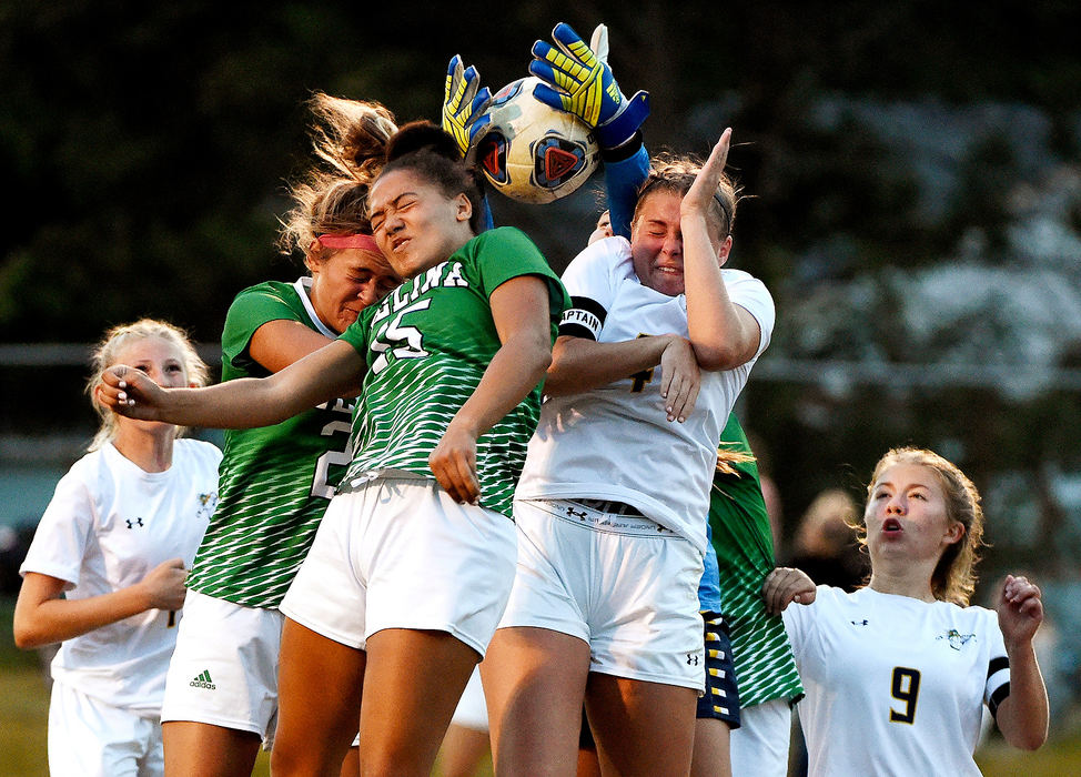 Sports - 2nd place - Ottawa-Glandorf’s Abby Warnecke (back) makes the save on goal as Kelsey Erford (right) battles Celina’s Taylor Klingshirn and Zoey Burns (15) off of a corner kick.(Daniel Melograna / The Daily Standard)