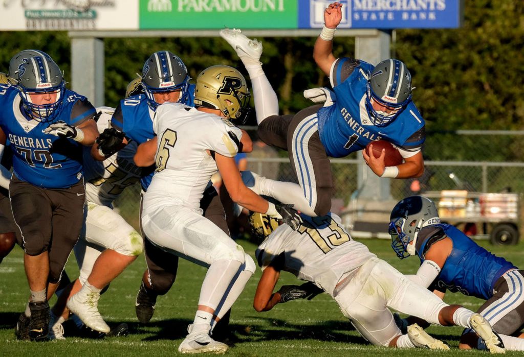 Sports - HM - Anthony Wayne’s Charles Renninger (1) goes airborne while running the ball during a game against Perrysburg at Anthony Wayne High School in Whitehouse.(Kurt Steiss / The Blade)