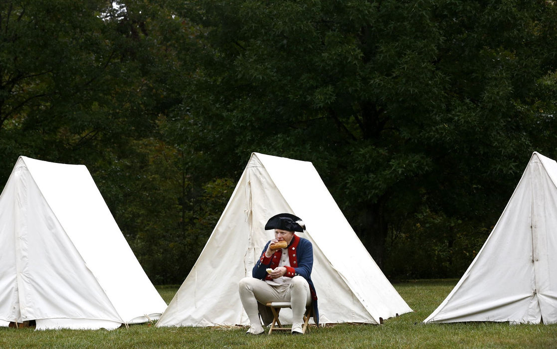 Feature - 2nd placeBrad Jarard of Cincinnati eats what he calls a "soldier's meal" of bread and cheese at a Revolutionary War reenactment held at Everal Barn and Homestead in Westerville. Jarard is a member of the 8th Pennsylvania Regiment. The reenactment is put on by the Brigade of the American Revolution and depicts the lives of soldiers during the American War for Independence.  (Fred Squillante / The Columbus Dispatch)