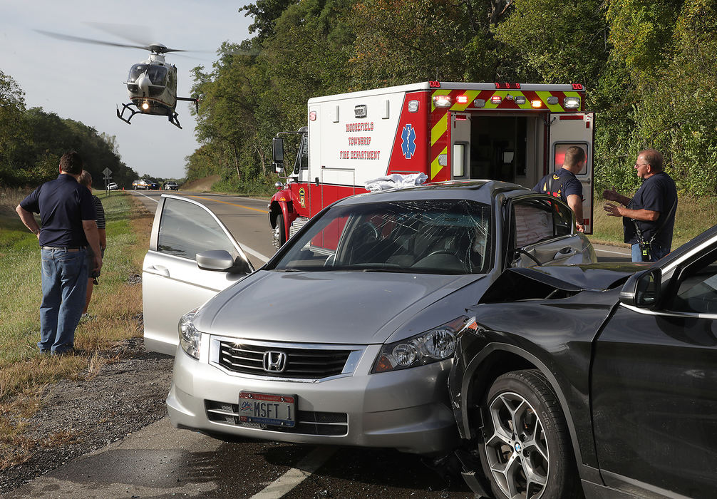 Spot News - 1st placeOne person was transported by medical helicopter and two were transported by medic units following a two car crash at the intersection of Moorefield Road and State Route 4 in Clark County.  (Bill Lackey / Springfield News-Sun)